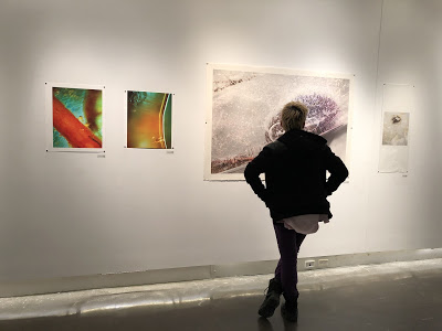 Audience member looking at thesis exhibition  